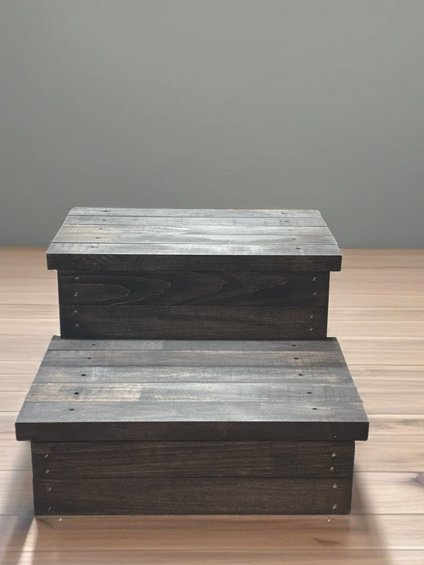 Rustic farmhouse 2-step wooden stool in vintage dark stain against a neutral wall background.